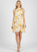 Woman wearing a yellow and white patterned dress on a white background