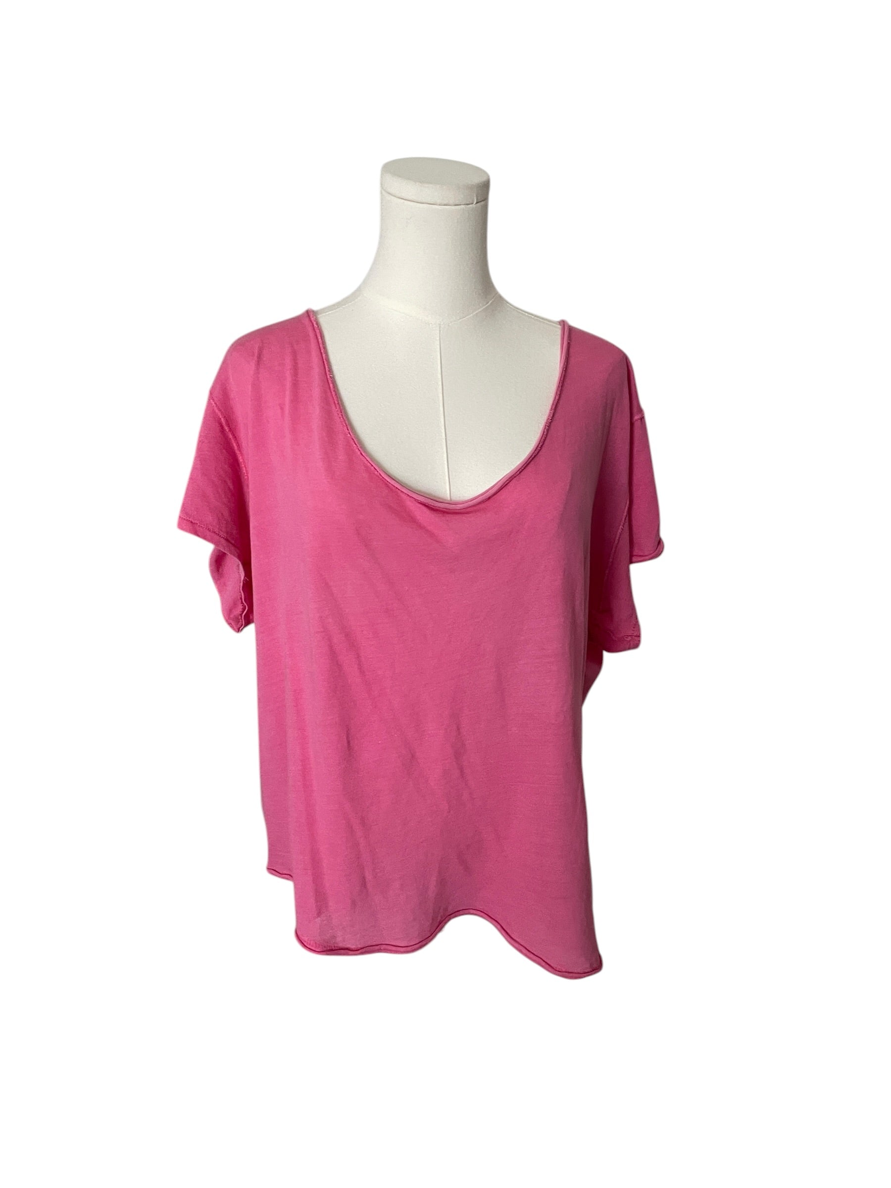 Pink t-shirt on a mannequin against a white background