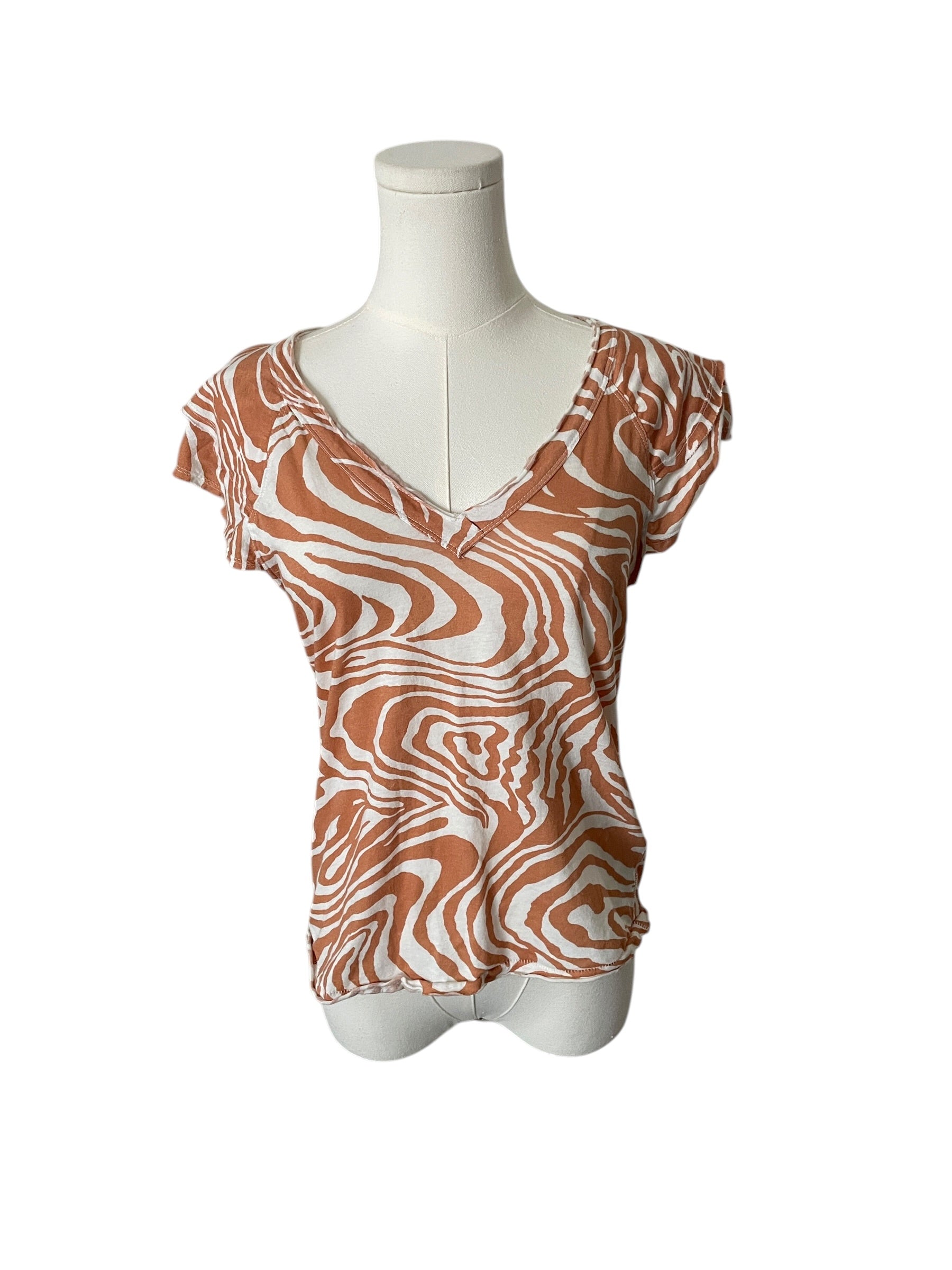 Zebra print top on a mannequin against a white background