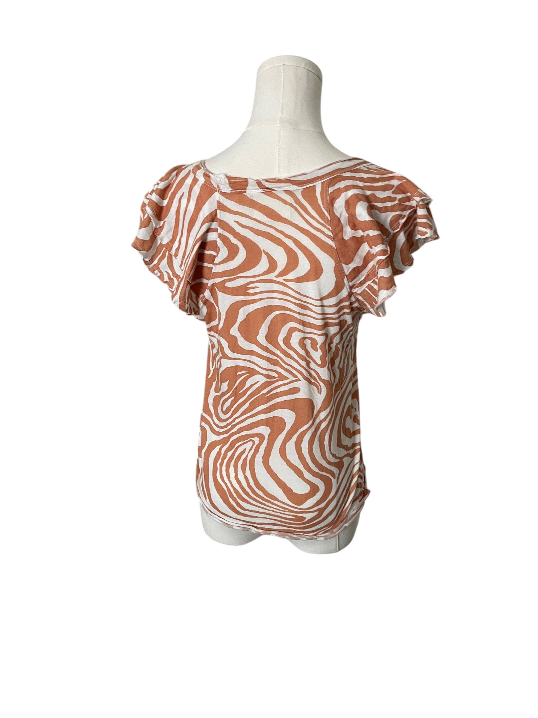 Zebra patterned top on a mannequin against a white background