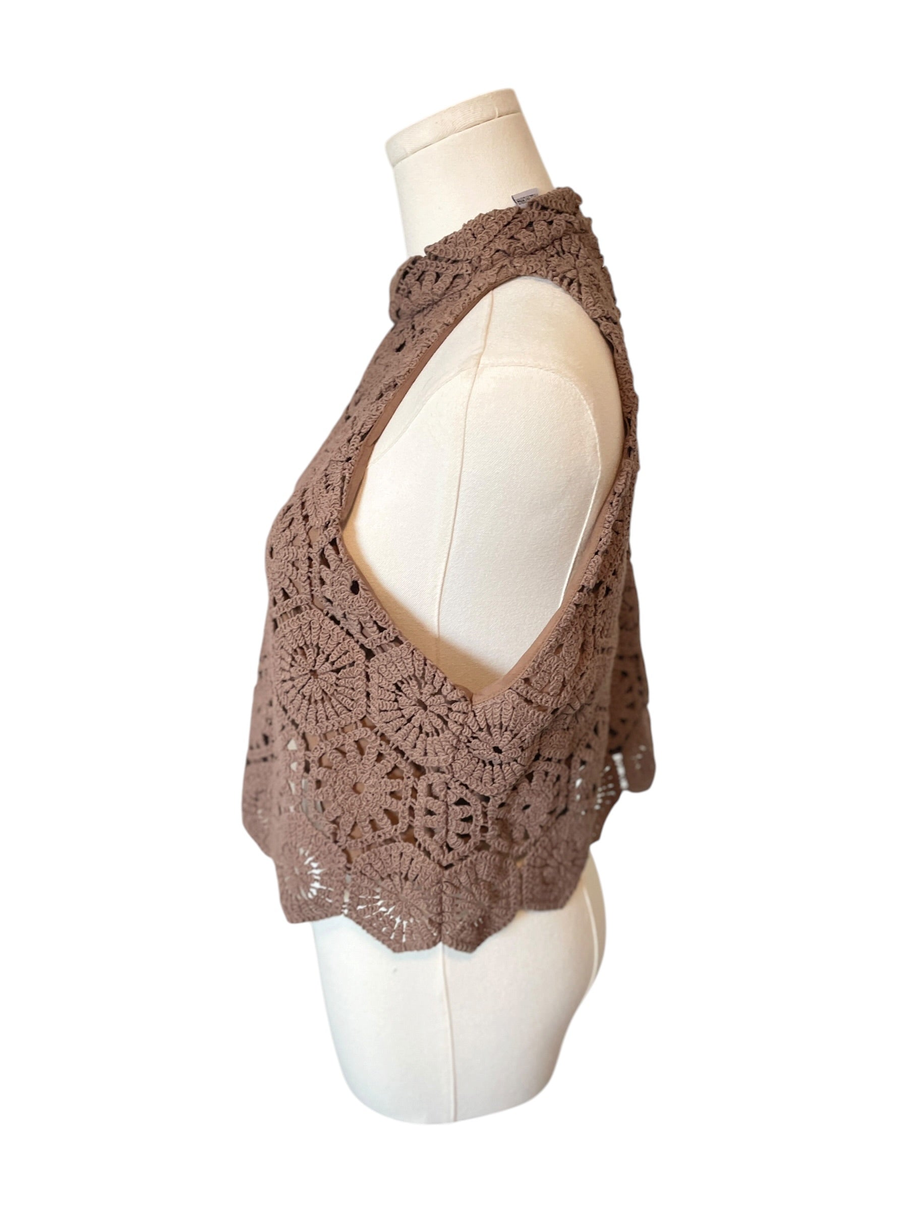 Brown crochet vest on a mannequin against a white background