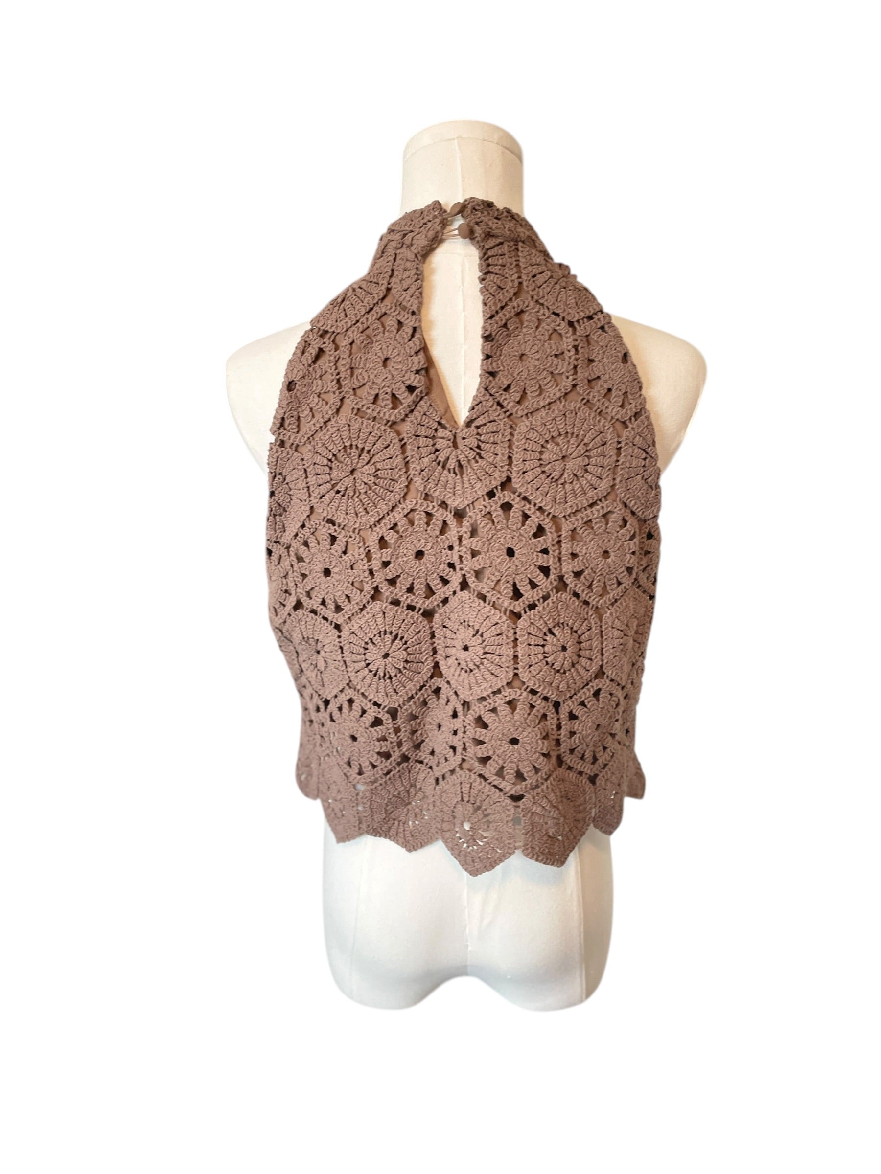 Brown crochet vest on a mannequin against a white background