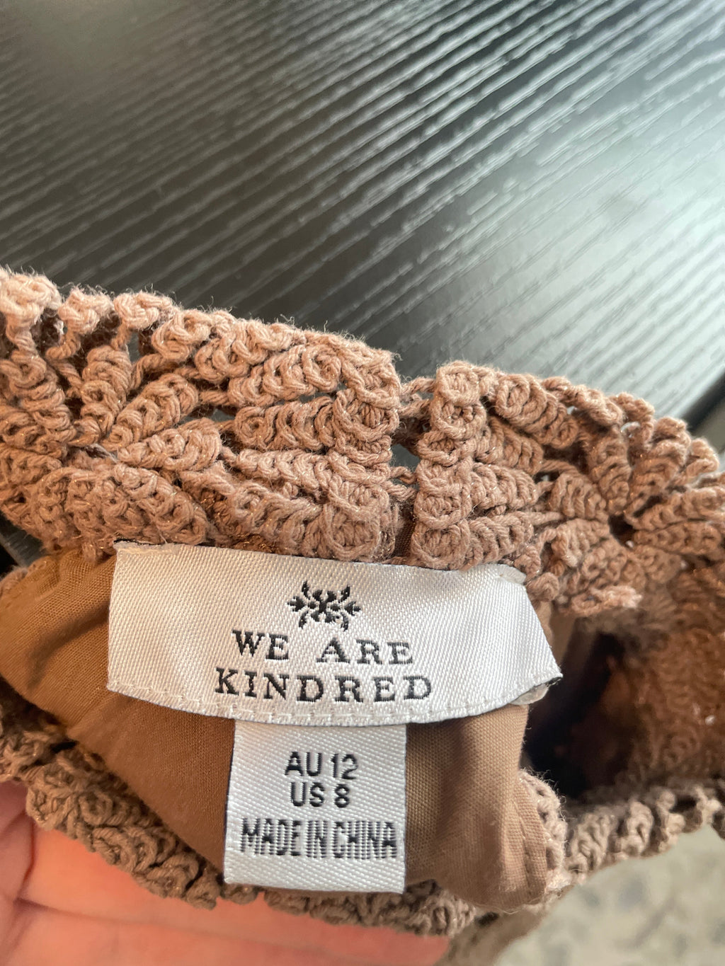 Close-up of a brown textured product with a visible label on a blurred background