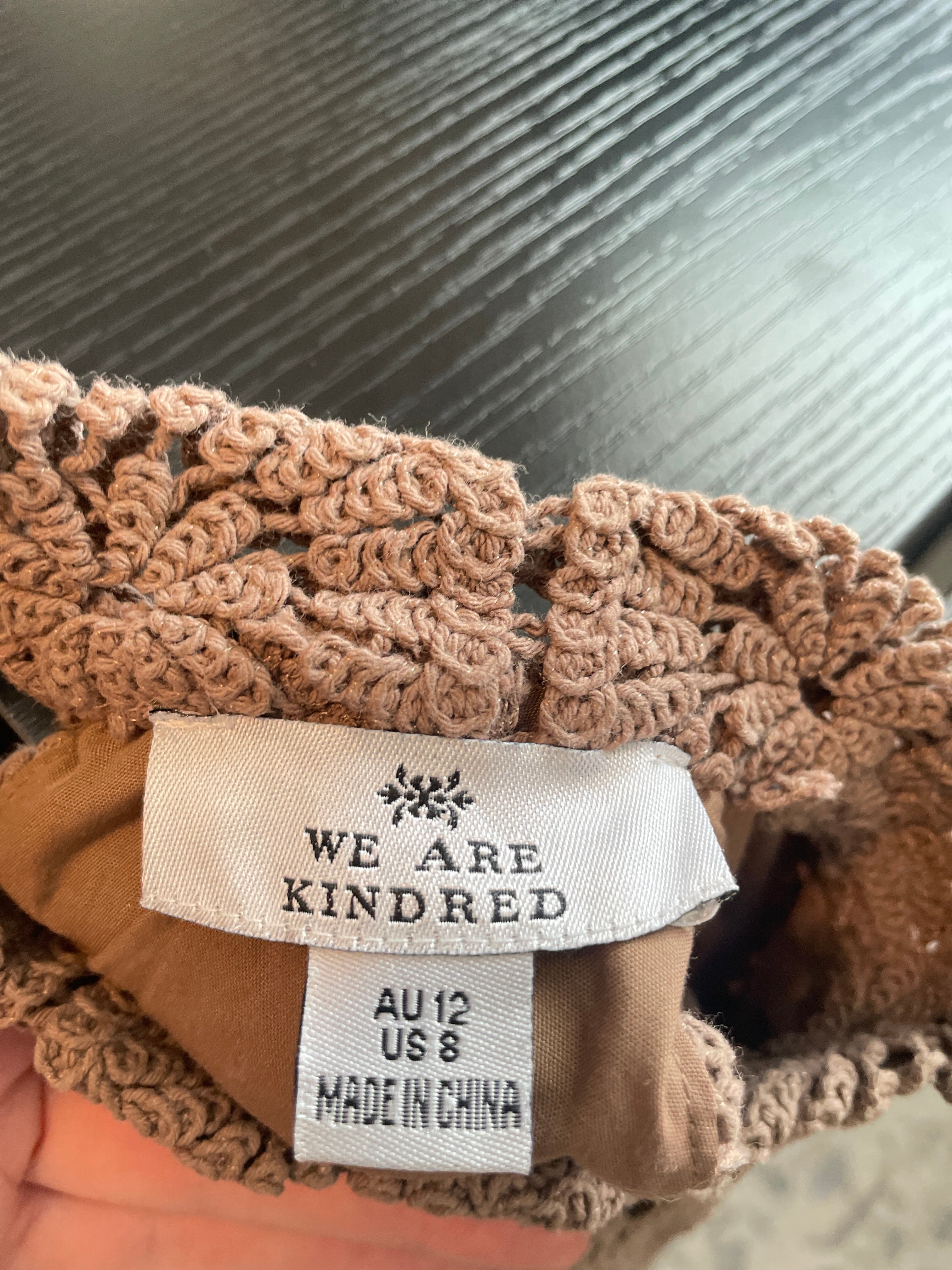 Close-up of a brown textured product with a visible label on a blurred background
