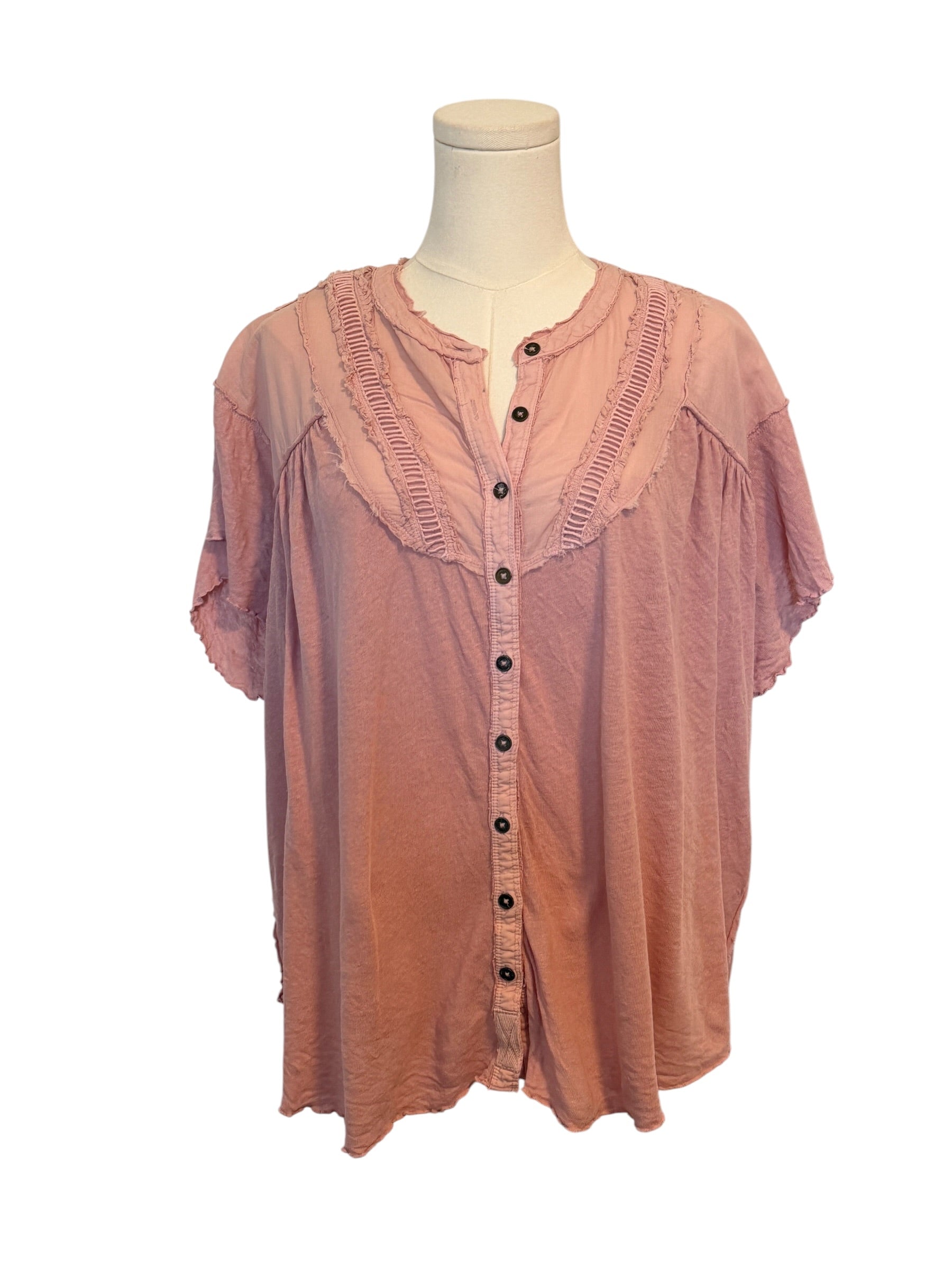 Pink blouse on a mannequin against a white background