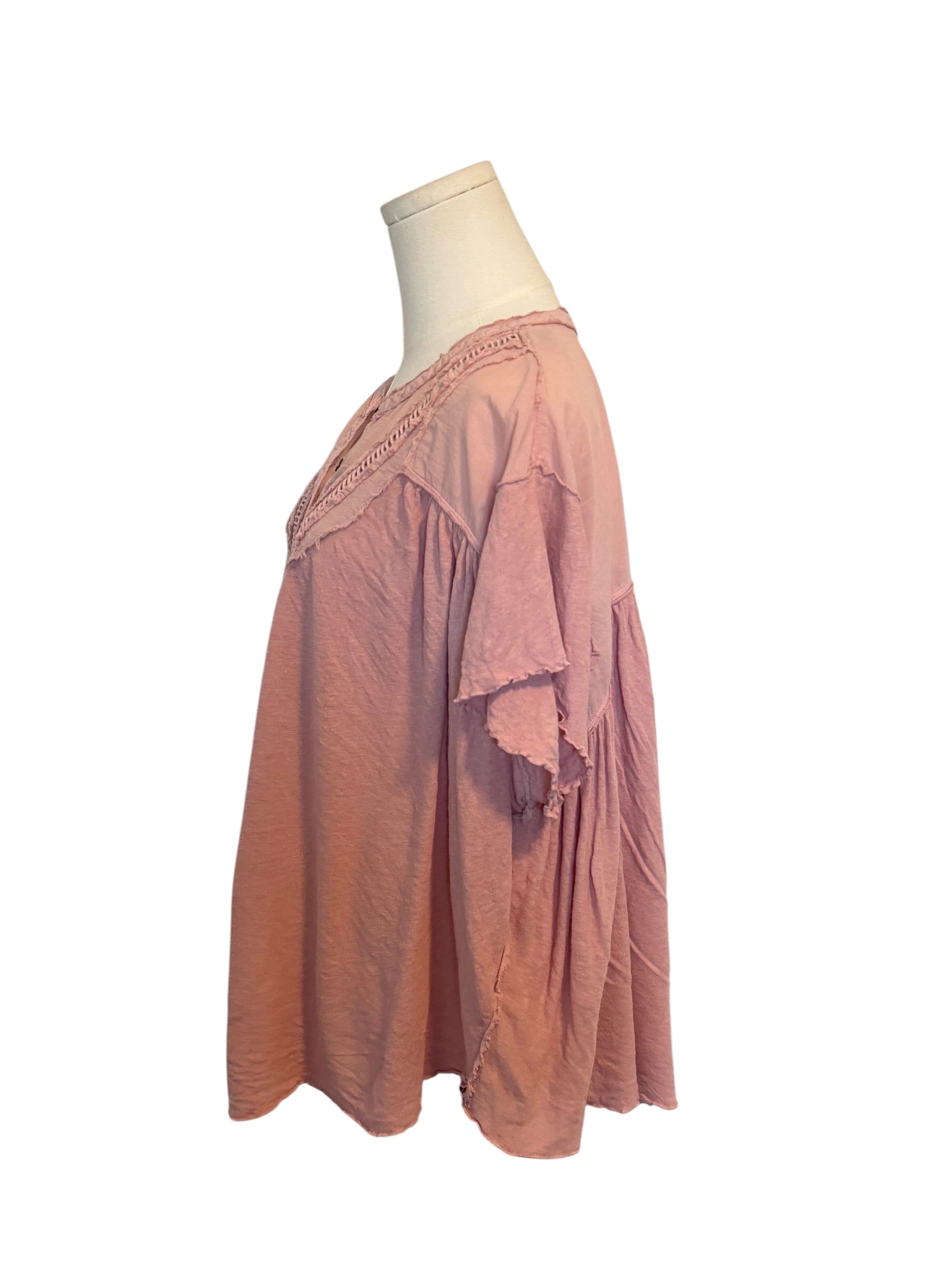 Pink dress on a mannequin against a white background