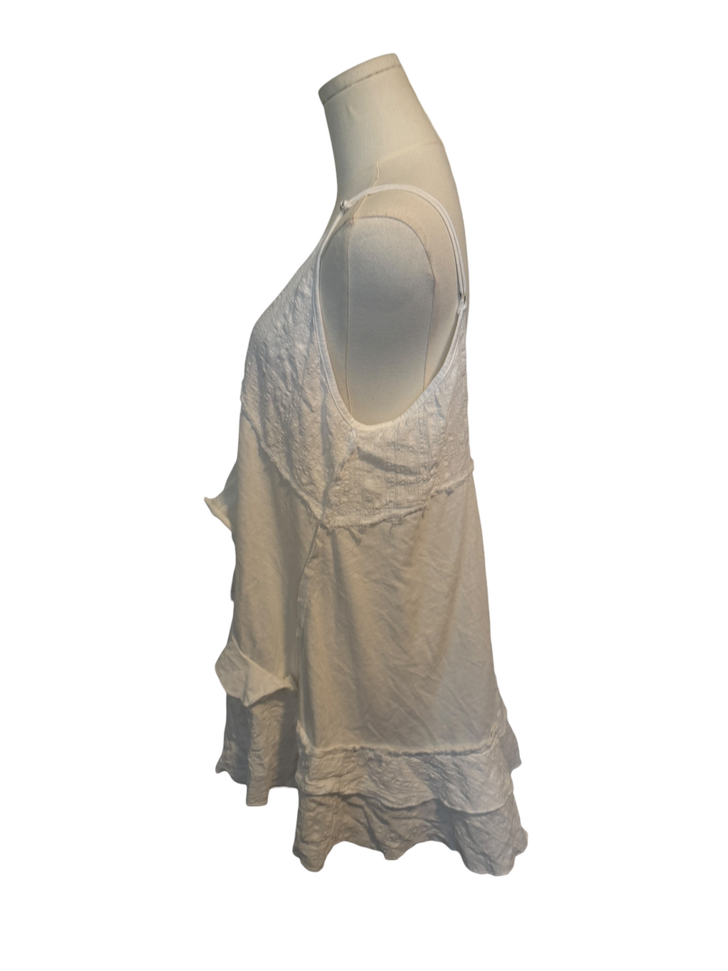 Beige sleeveless top on a mannequin against a white background