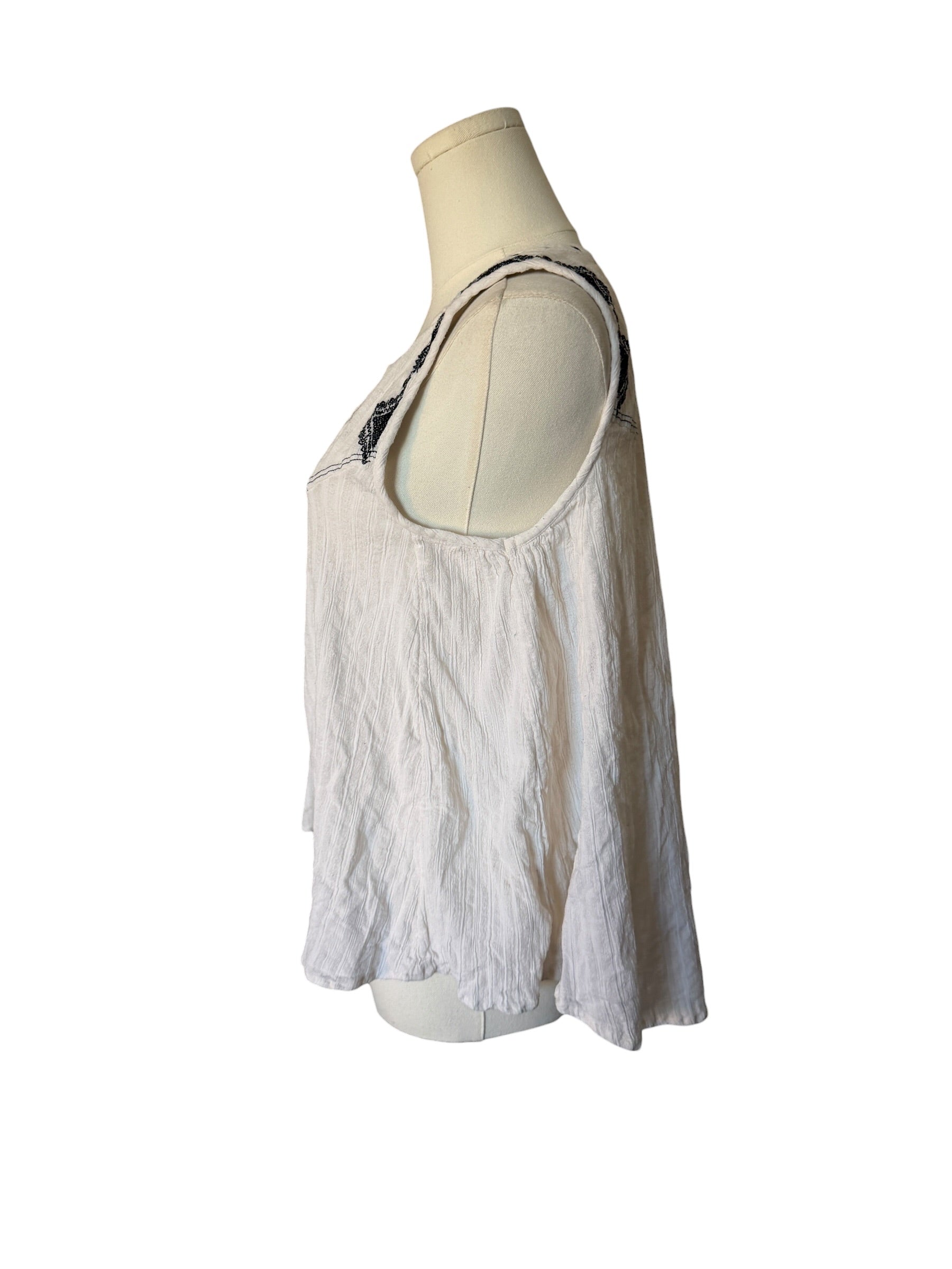 White lace top on a mannequin against a white background