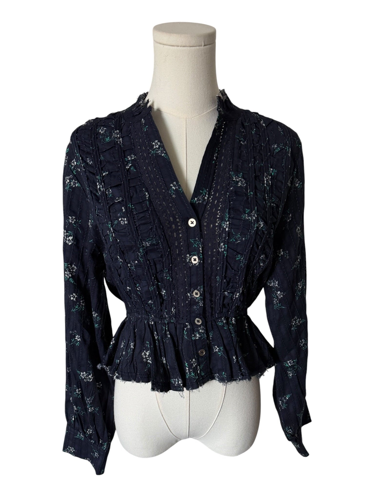 Navy floral blouse on a mannequin against a white background