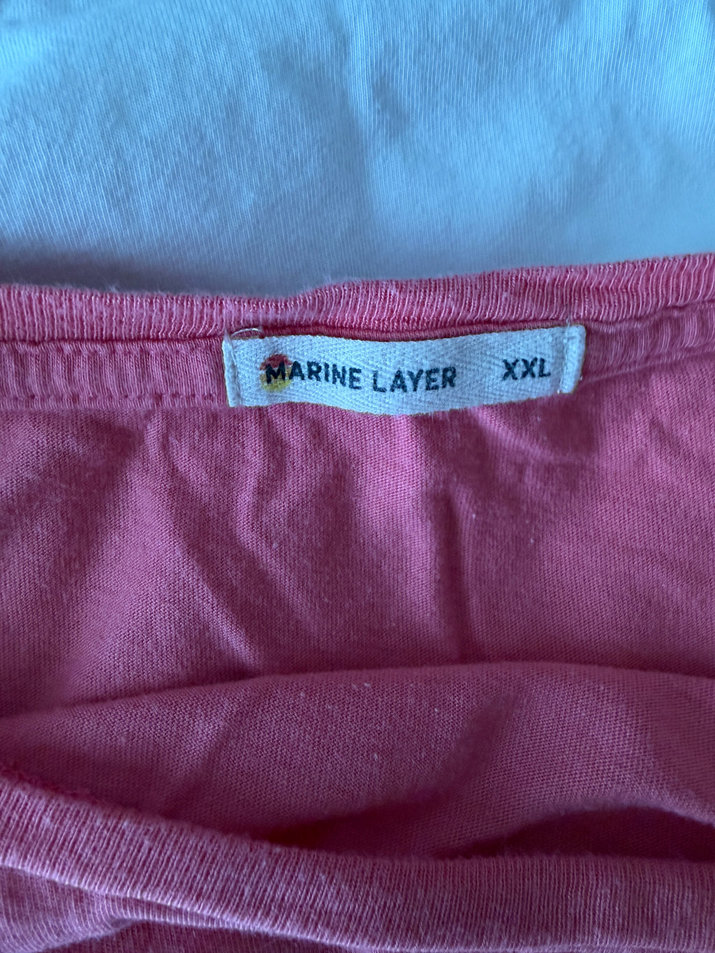 Maroon garment with a label on a light blue background