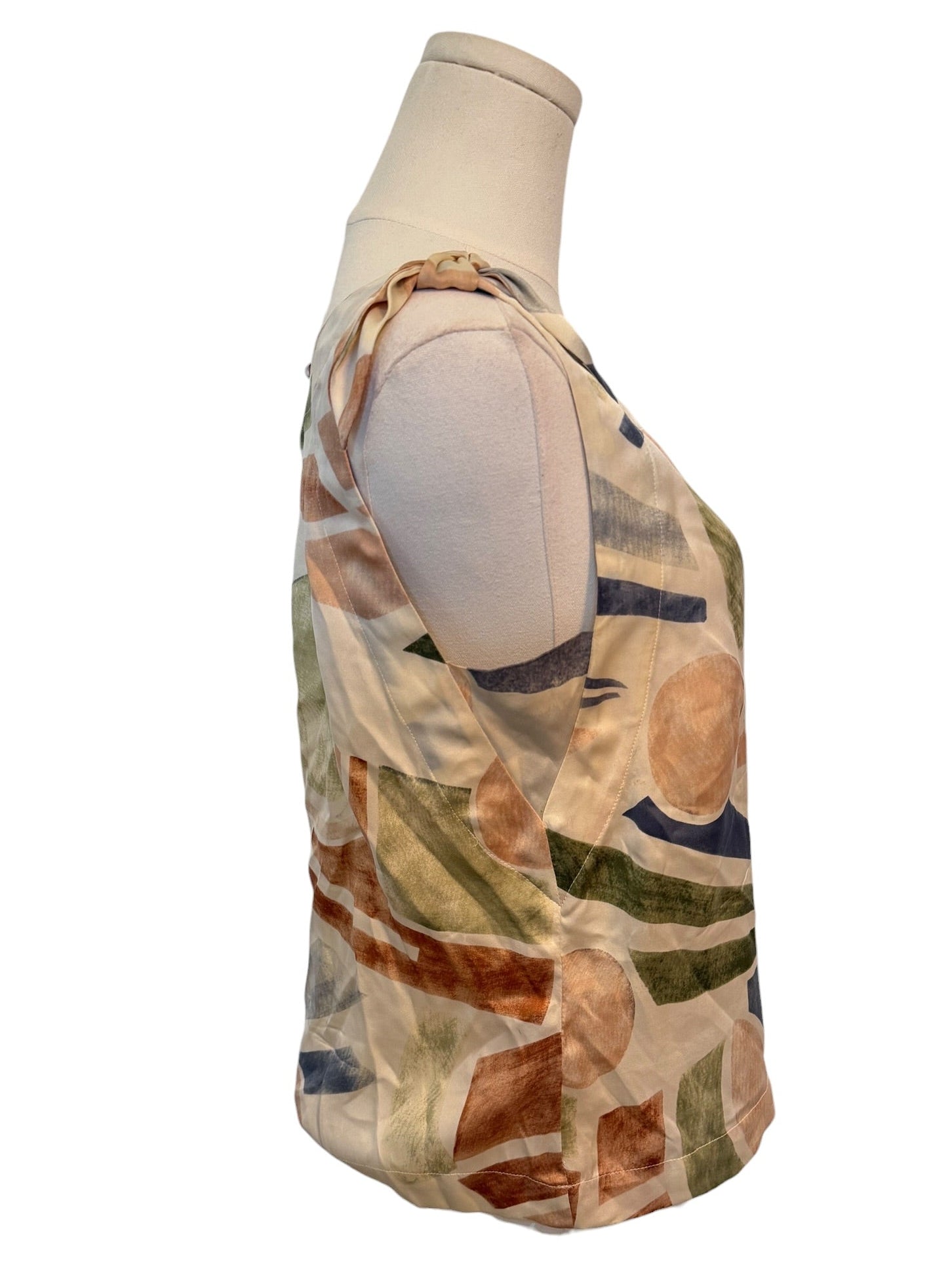 Colorful patterned sleeveless top on a mannequin against a white background
