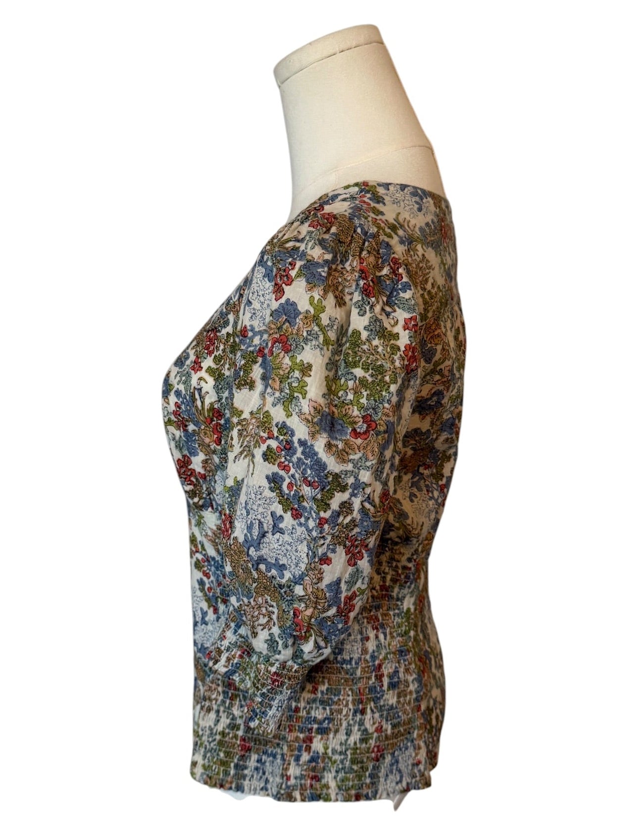 Floral patterned dress on a mannequin against a white background