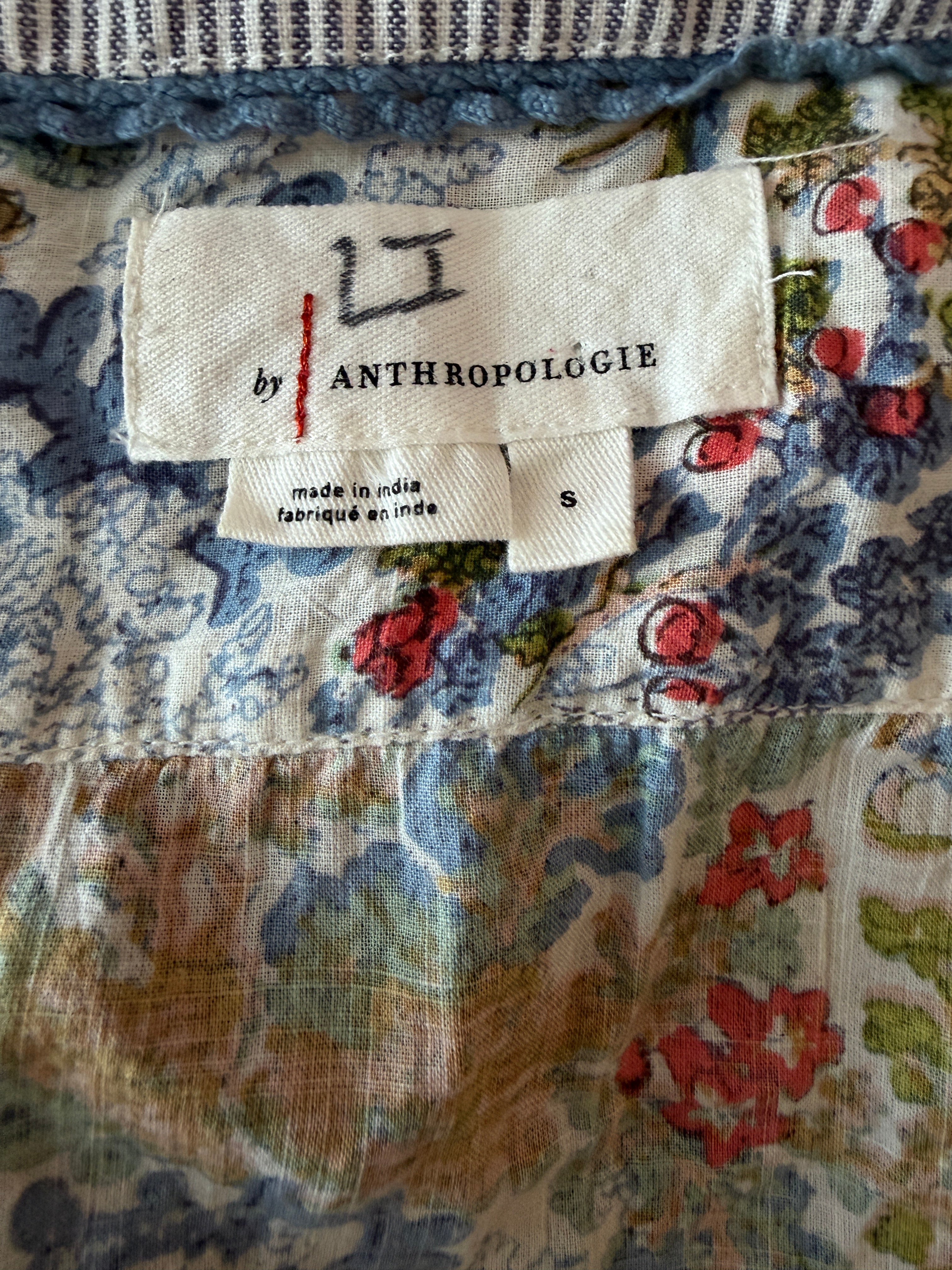 Close-up of a floral fabric with an Anthropologie label.