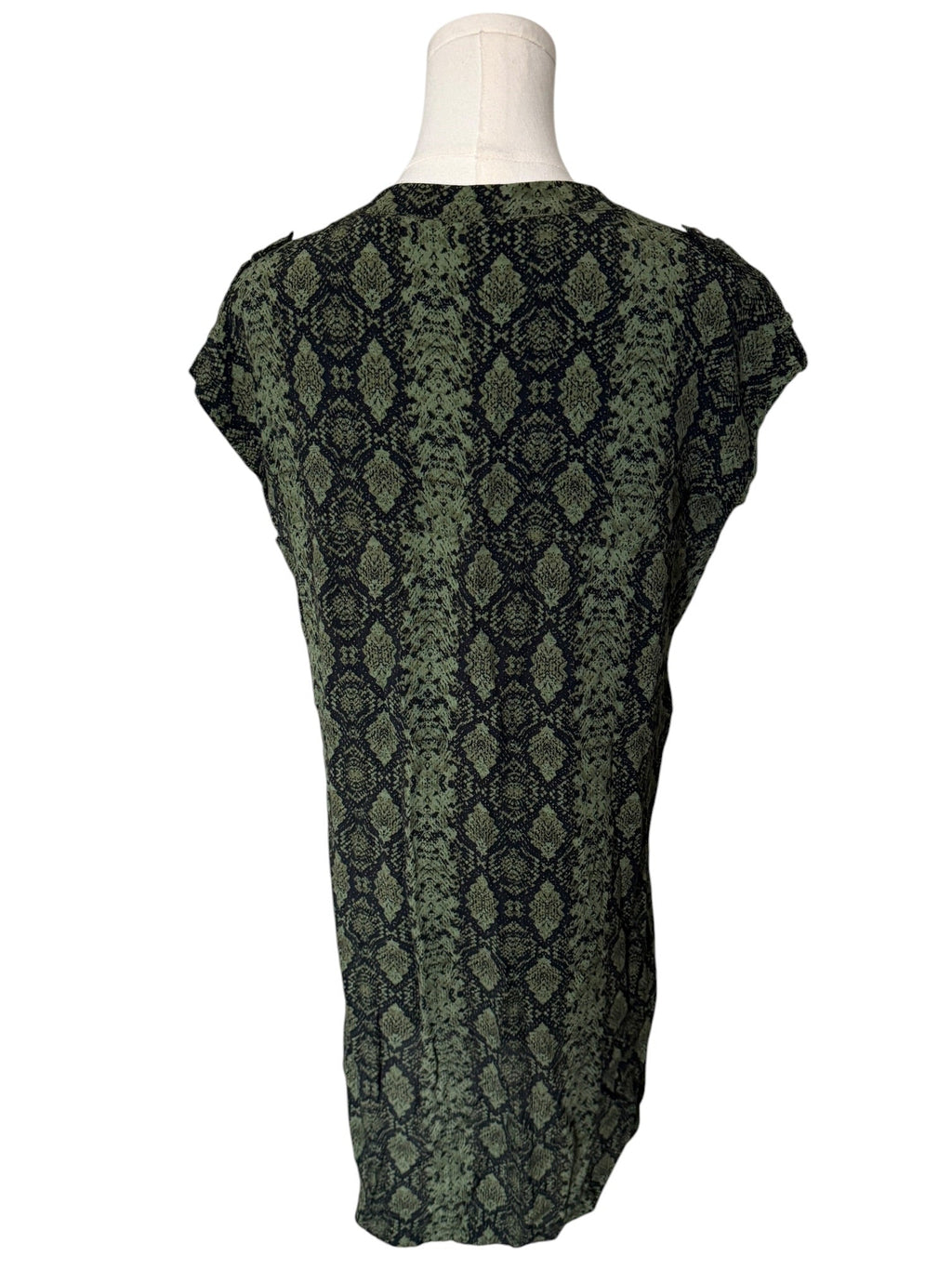Green patterned top on a mannequin against a white background