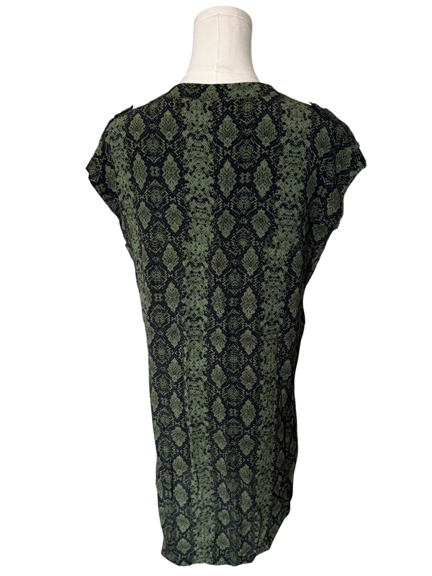 Green patterned top on a mannequin against a white background