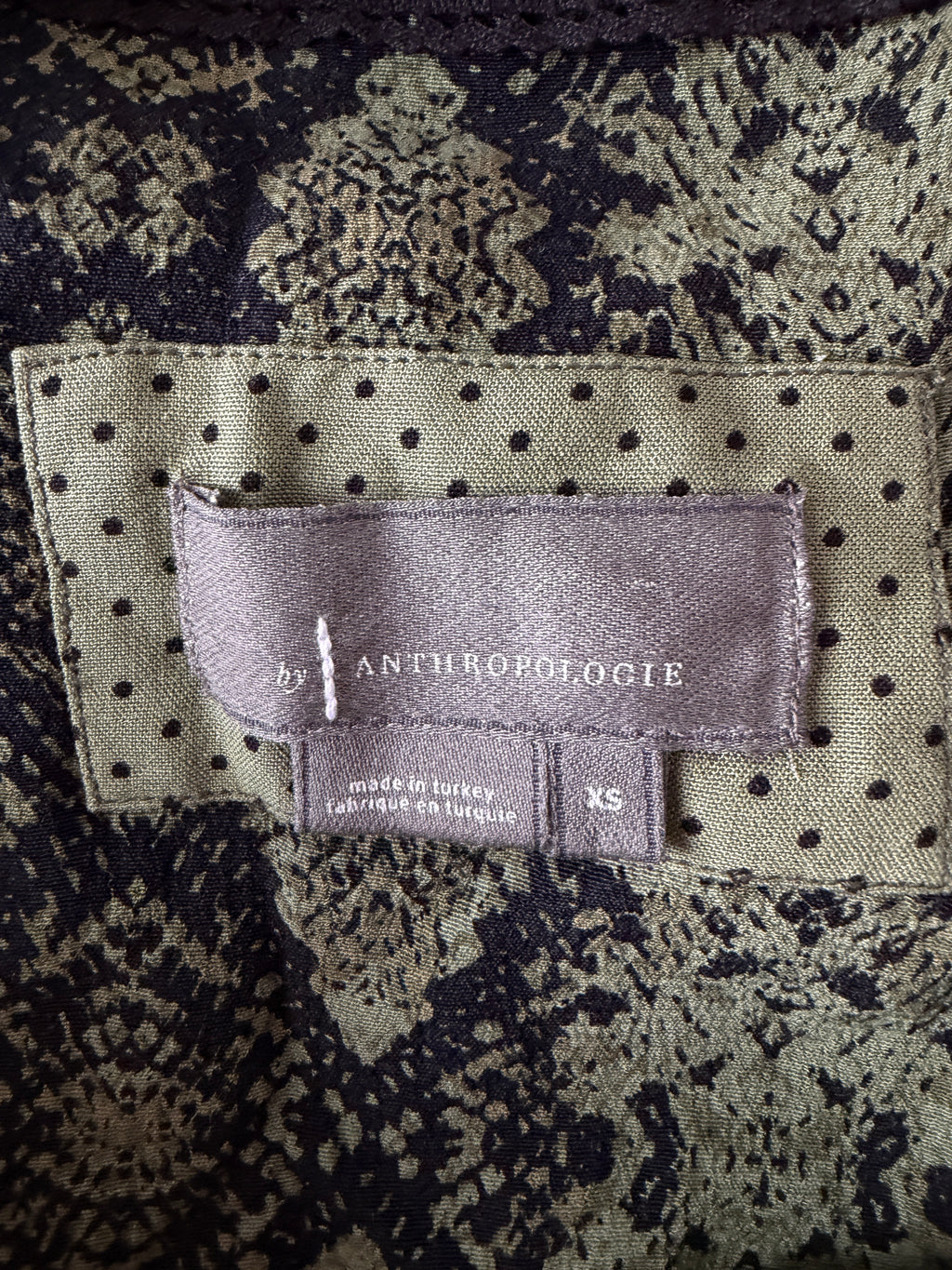 Close-up of a patterned fabric with an Anthropologie label.