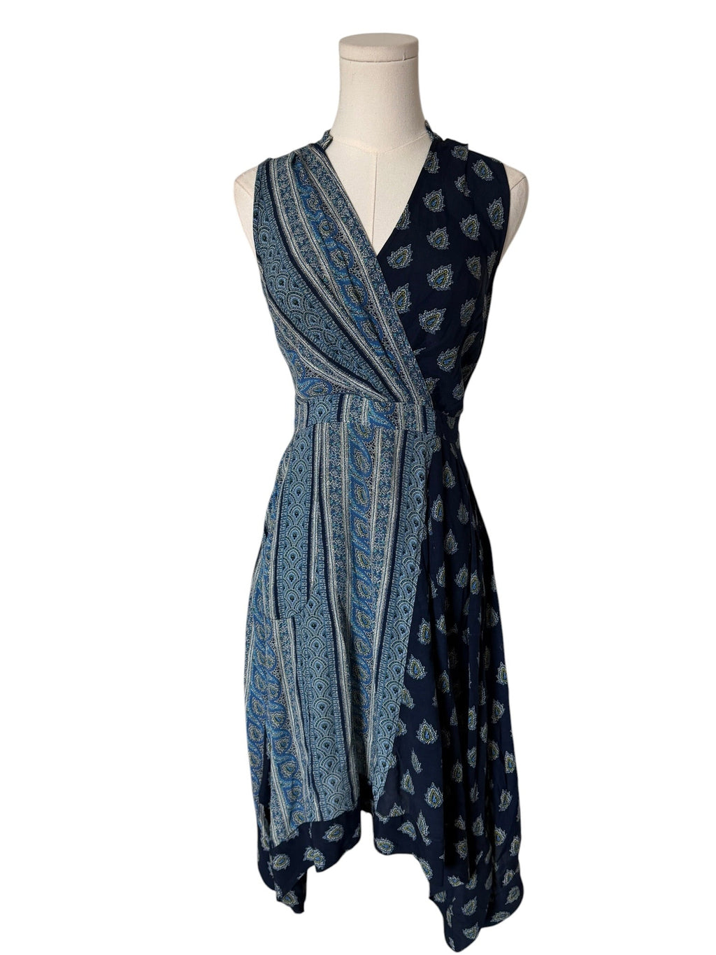 Blue patterned dress on a mannequin against a white background