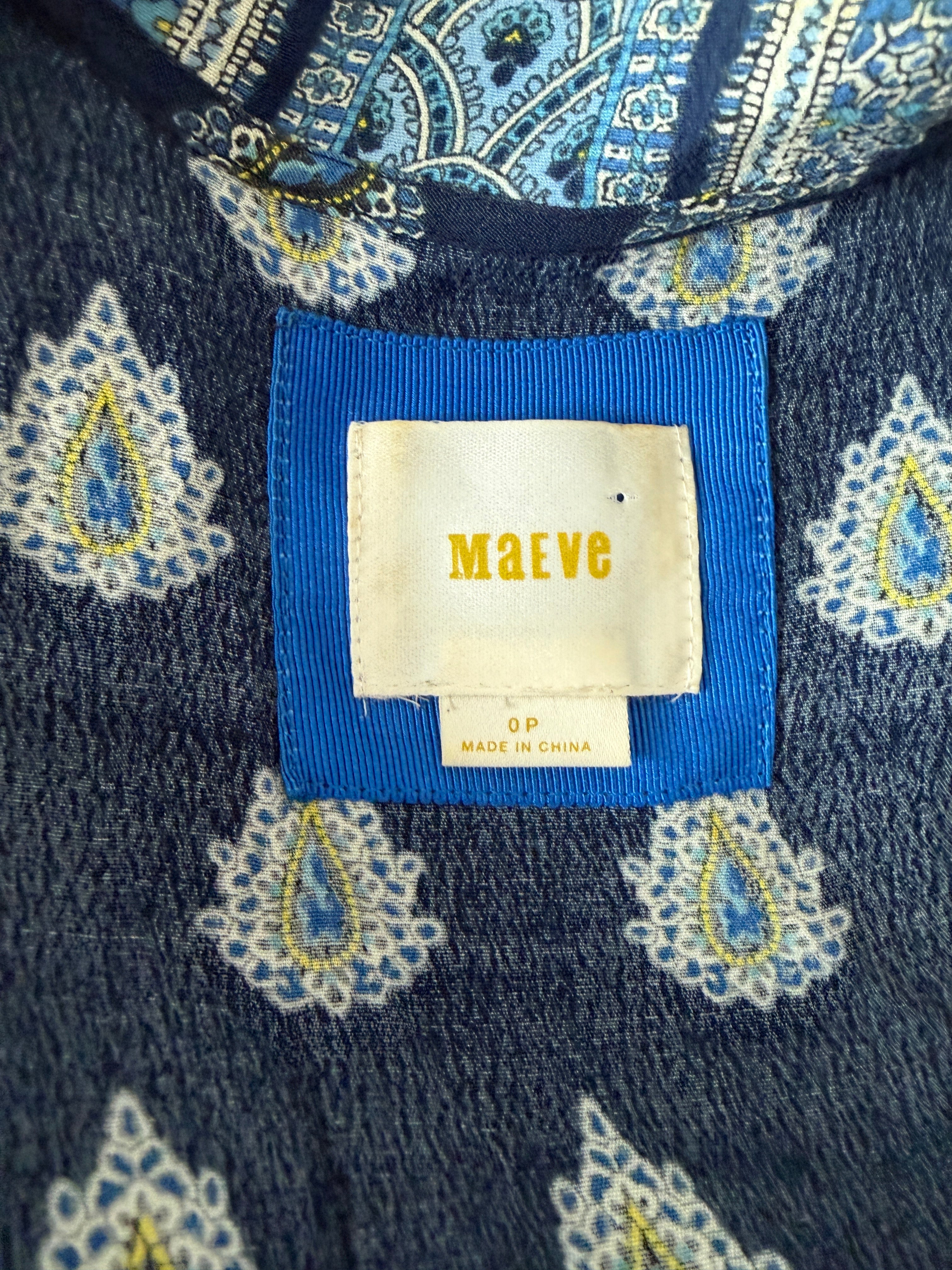 Navy blue fabric with white and yellow paisley patterns and a visible brand label.