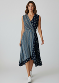 Woman wearing a blue patterned dress on a white background