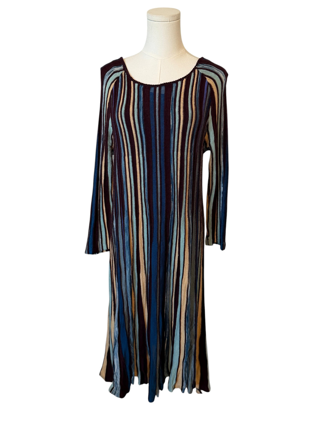 Striped dress on a mannequin against a white background