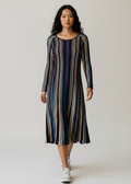 Woman wearing a striped dress on a plain background