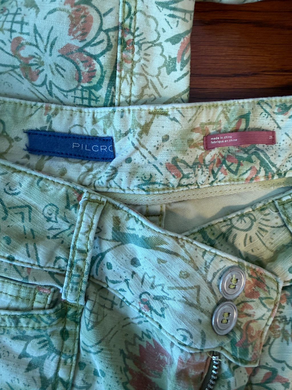 Close-up of a patterned fabric with visible branding labels.
