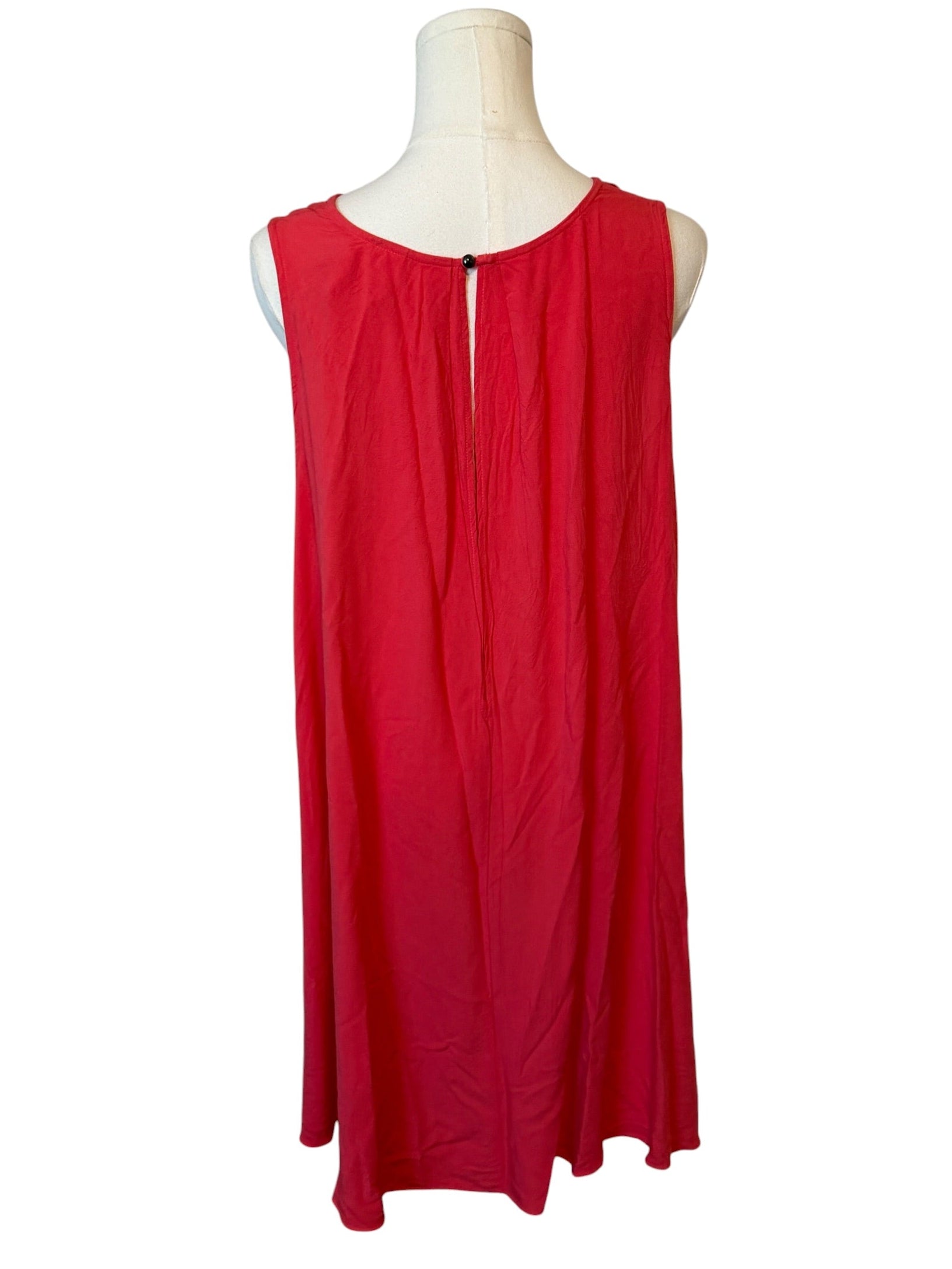 Red sleeveless dress on a mannequin against a white background