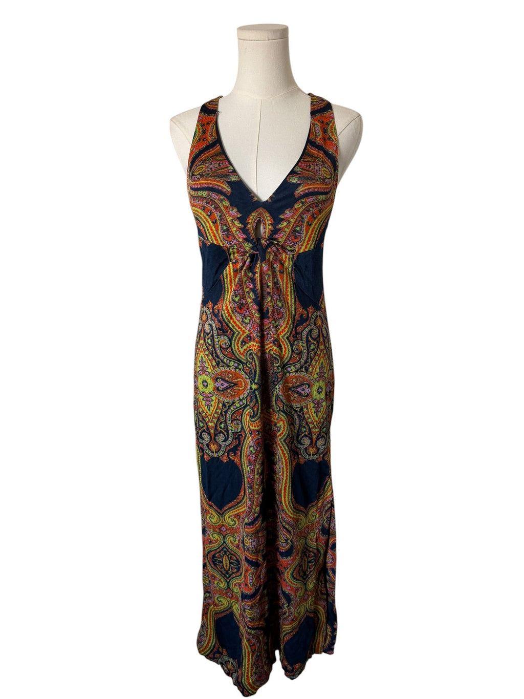 Colorful patterned dress on a mannequin against a white background