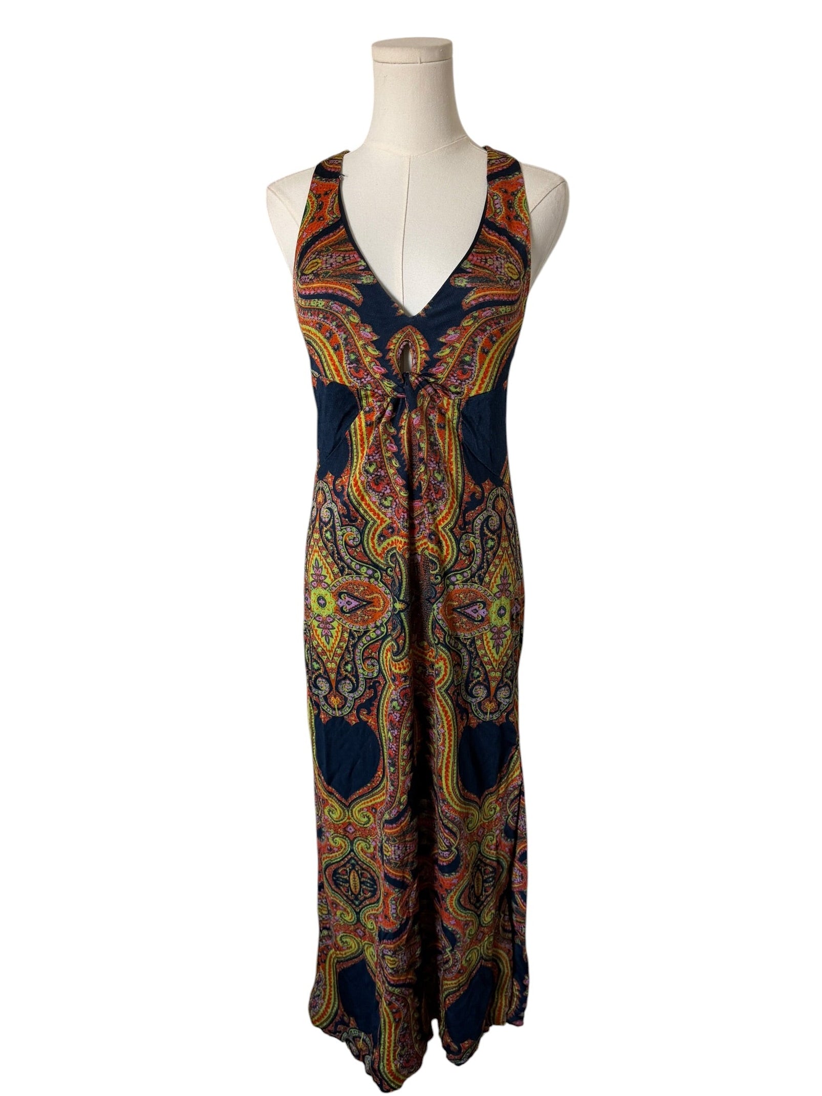 Colorful patterned dress on a mannequin against a white background