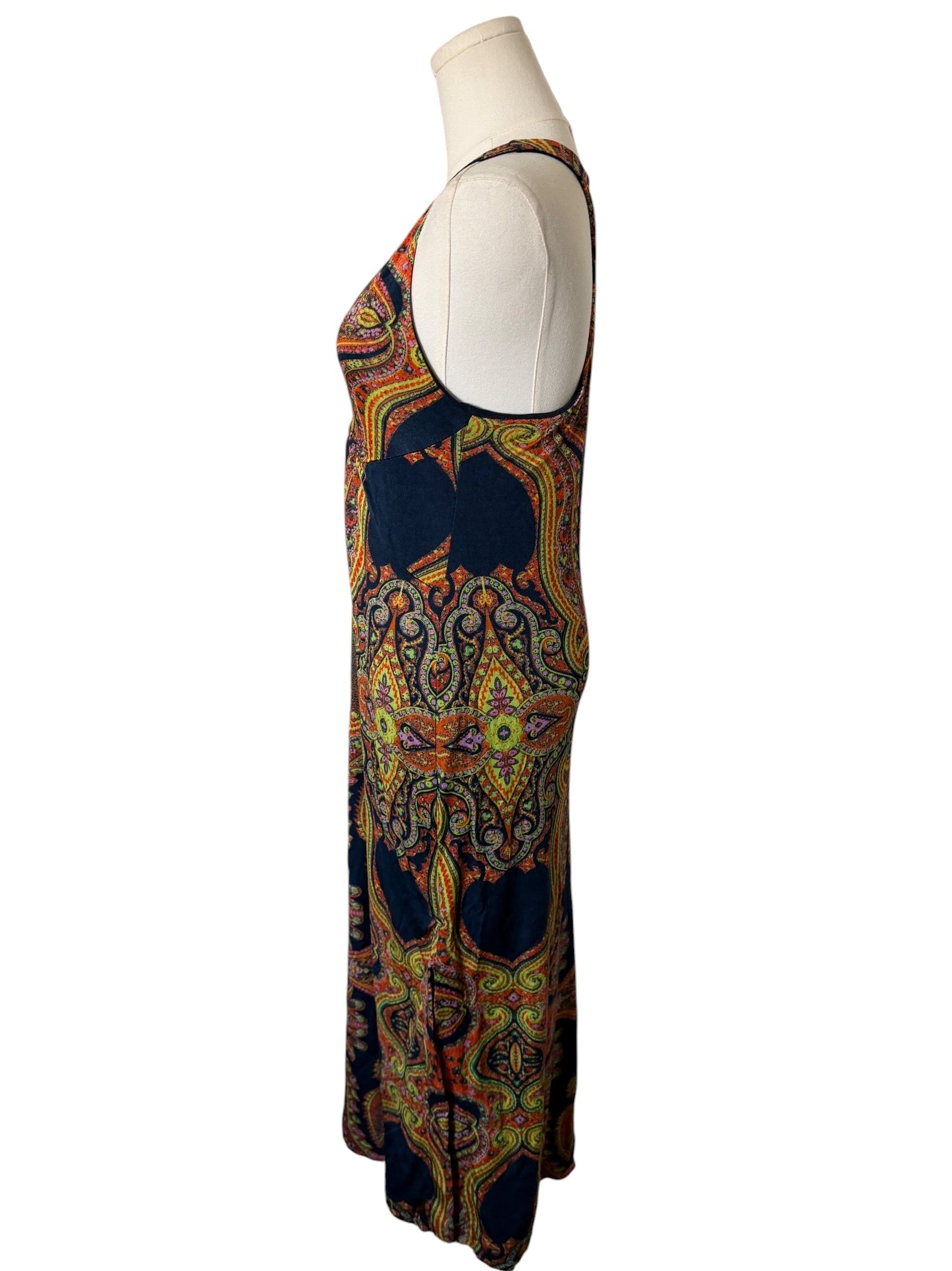 Colorful patterned dress on a mannequin against a white background