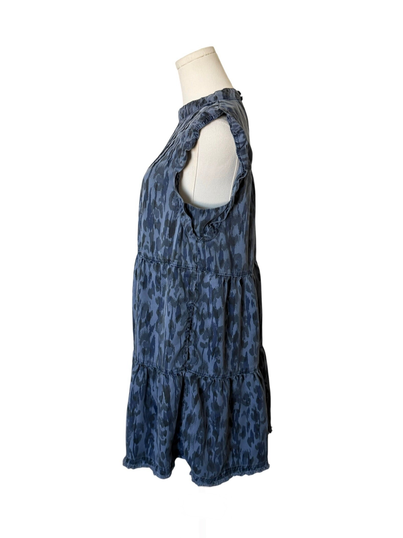 Blue patterned dress on a mannequin against a white background