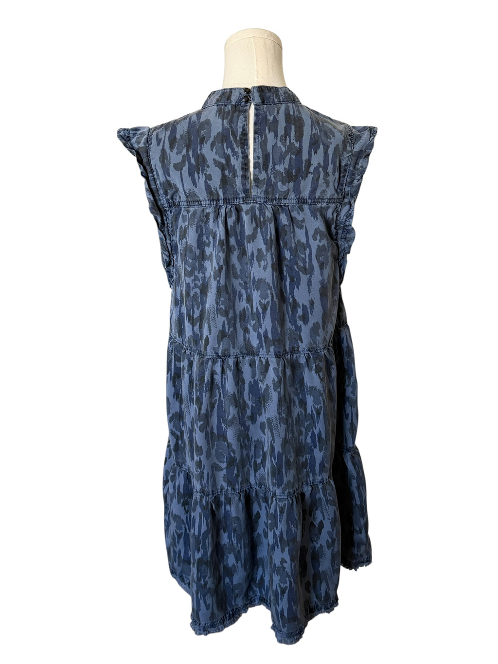 Blue patterned dress on a mannequin against a white background