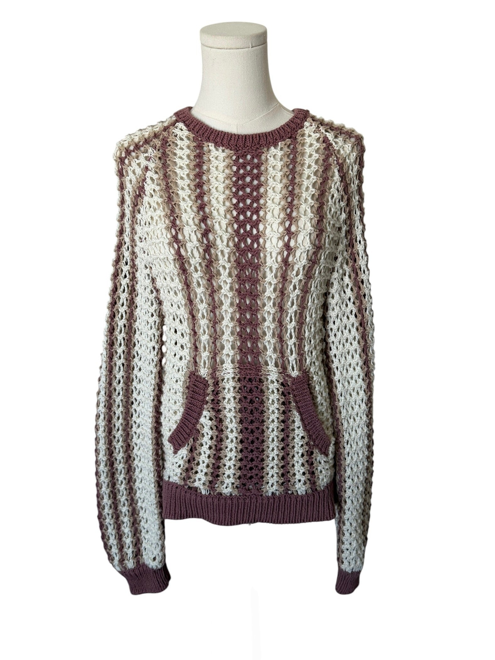 Knitted sweater with a pattern on a mannequin against a white background