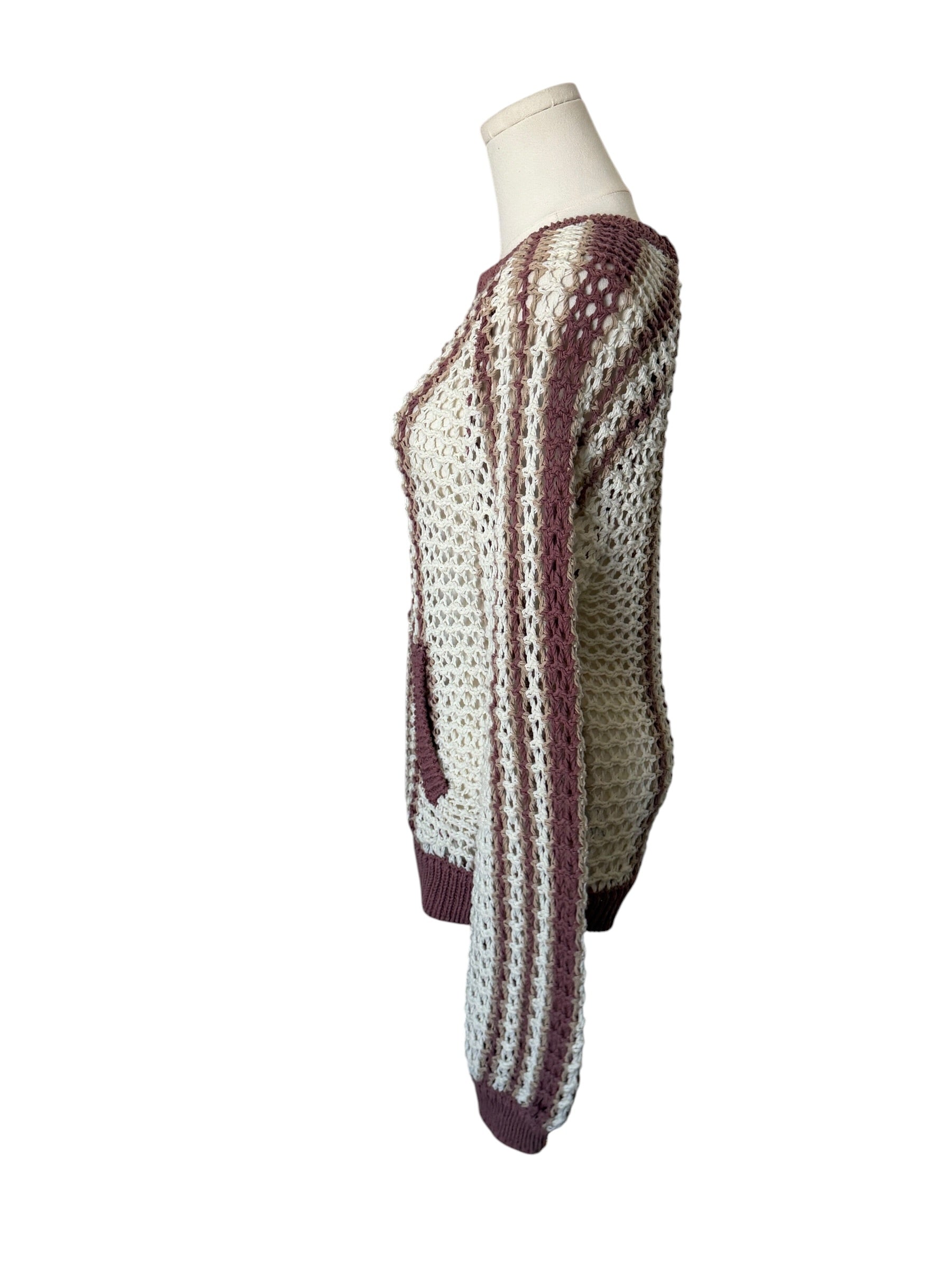 Knitted poncho with a pattern on a mannequin against a white background