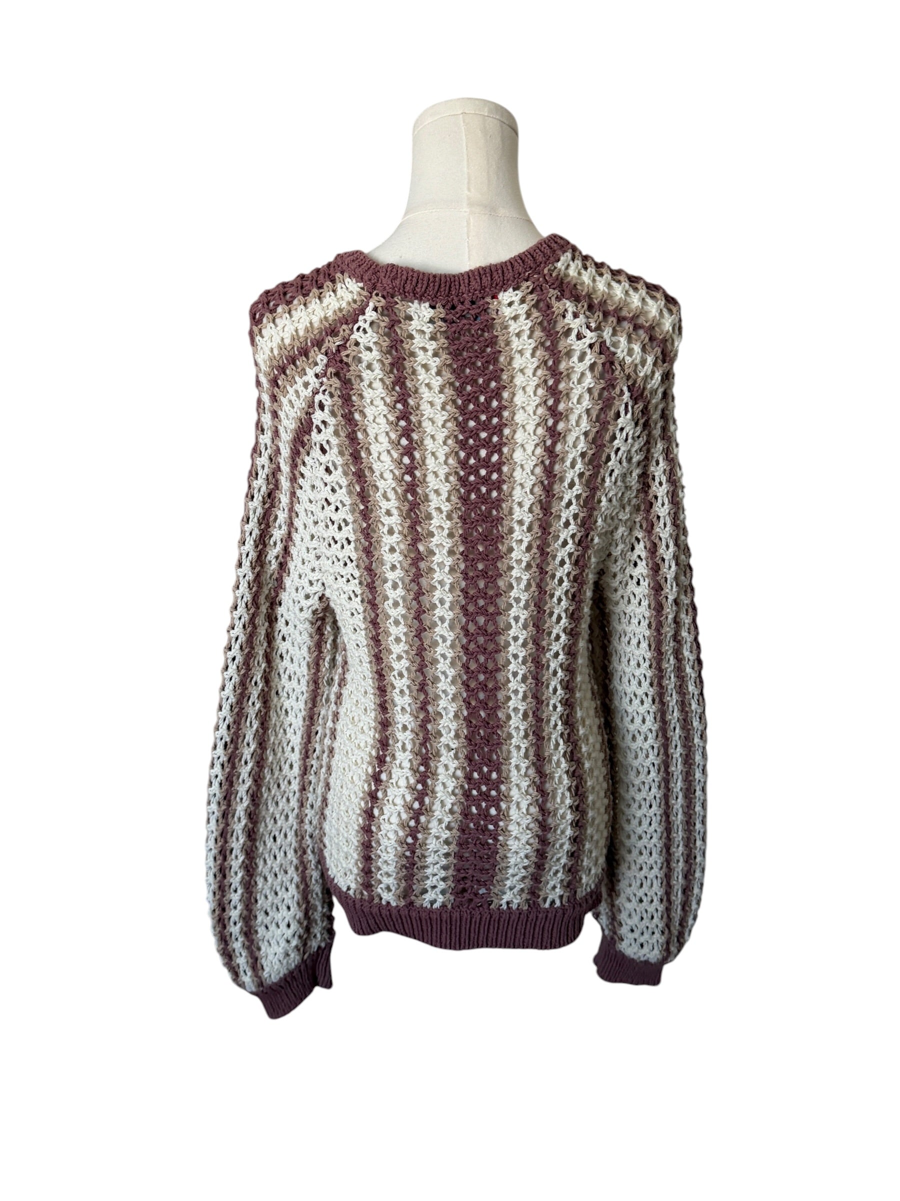 Knitted sweater on a mannequin against a white background