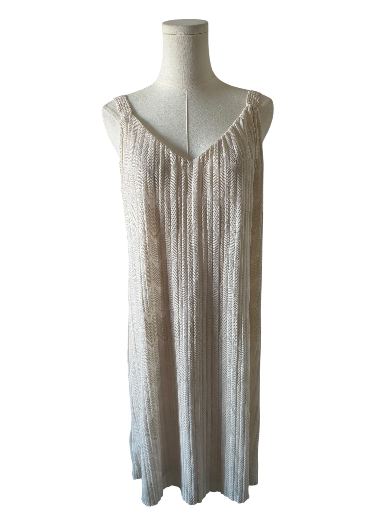 Mannequin wearing a beige sleeveless dress on a white background
