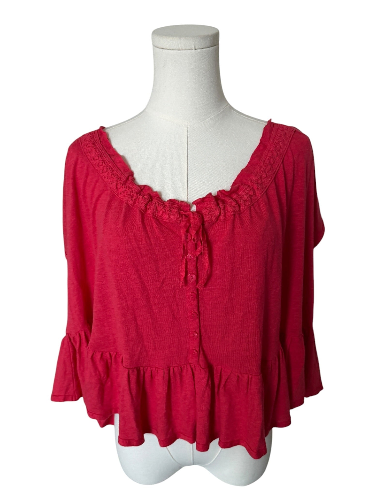 Red blouse on a mannequin against a white background