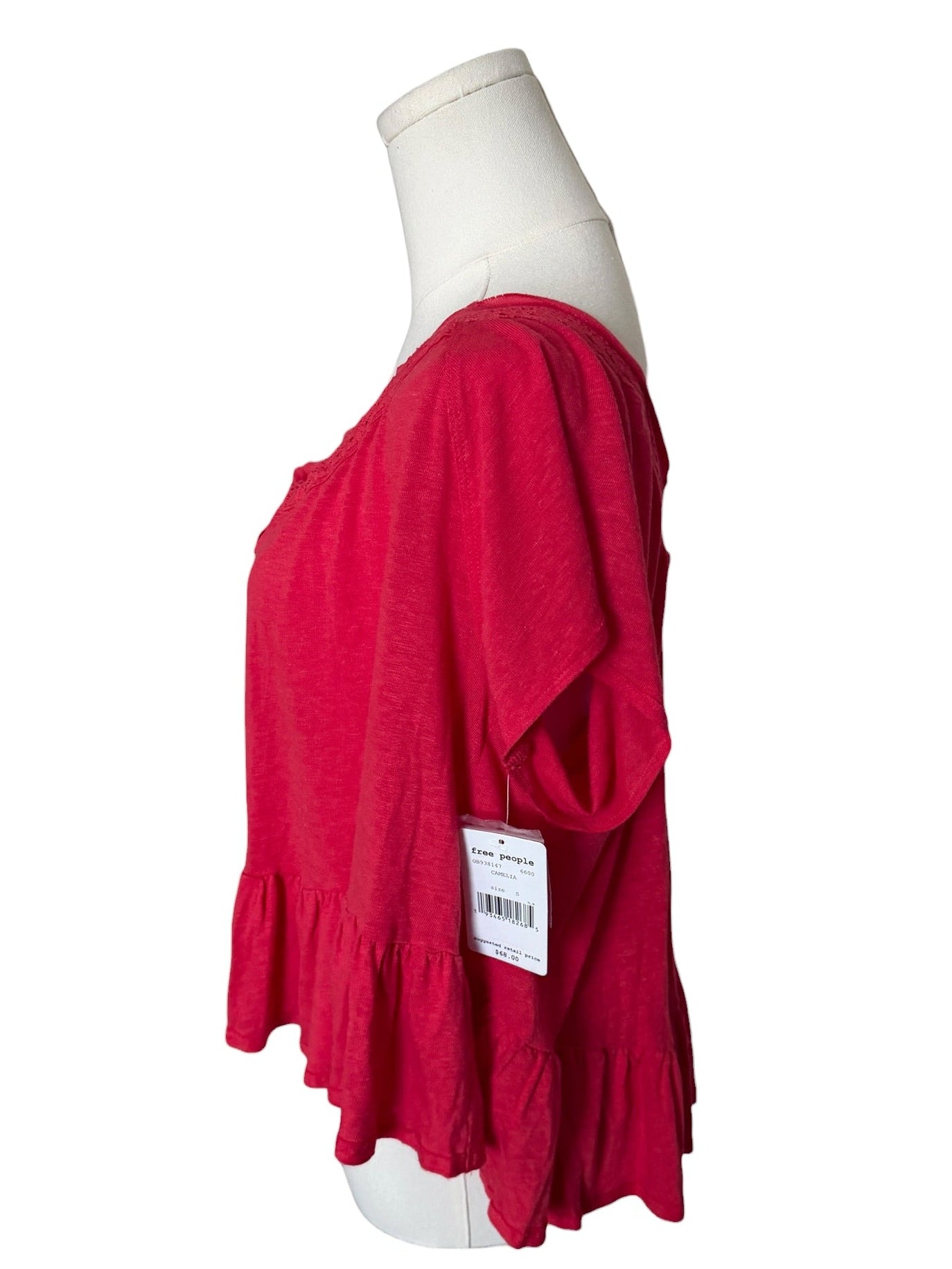 Red top on a mannequin with a white background