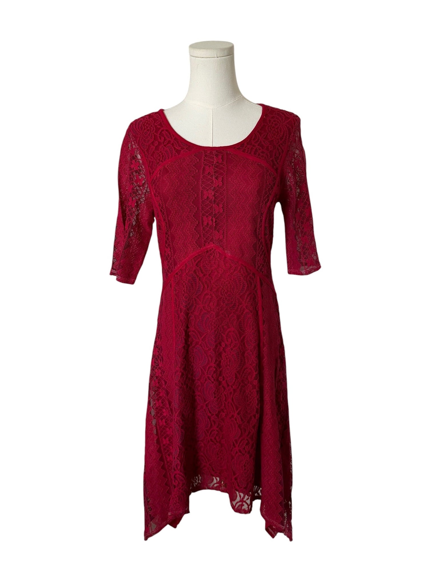 Red lace dress on a mannequin against a white background