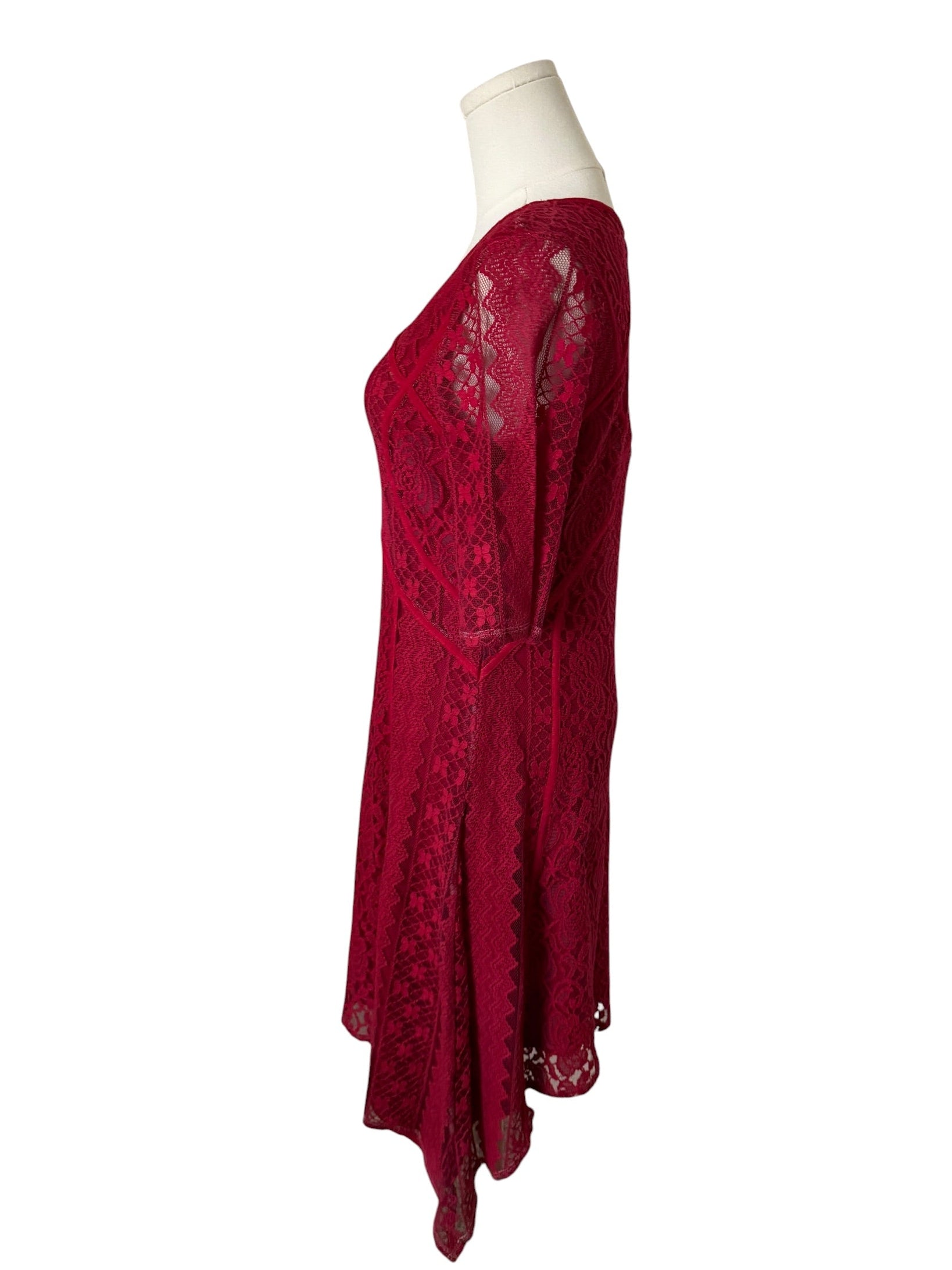 Red lace dress on a mannequin against a white background