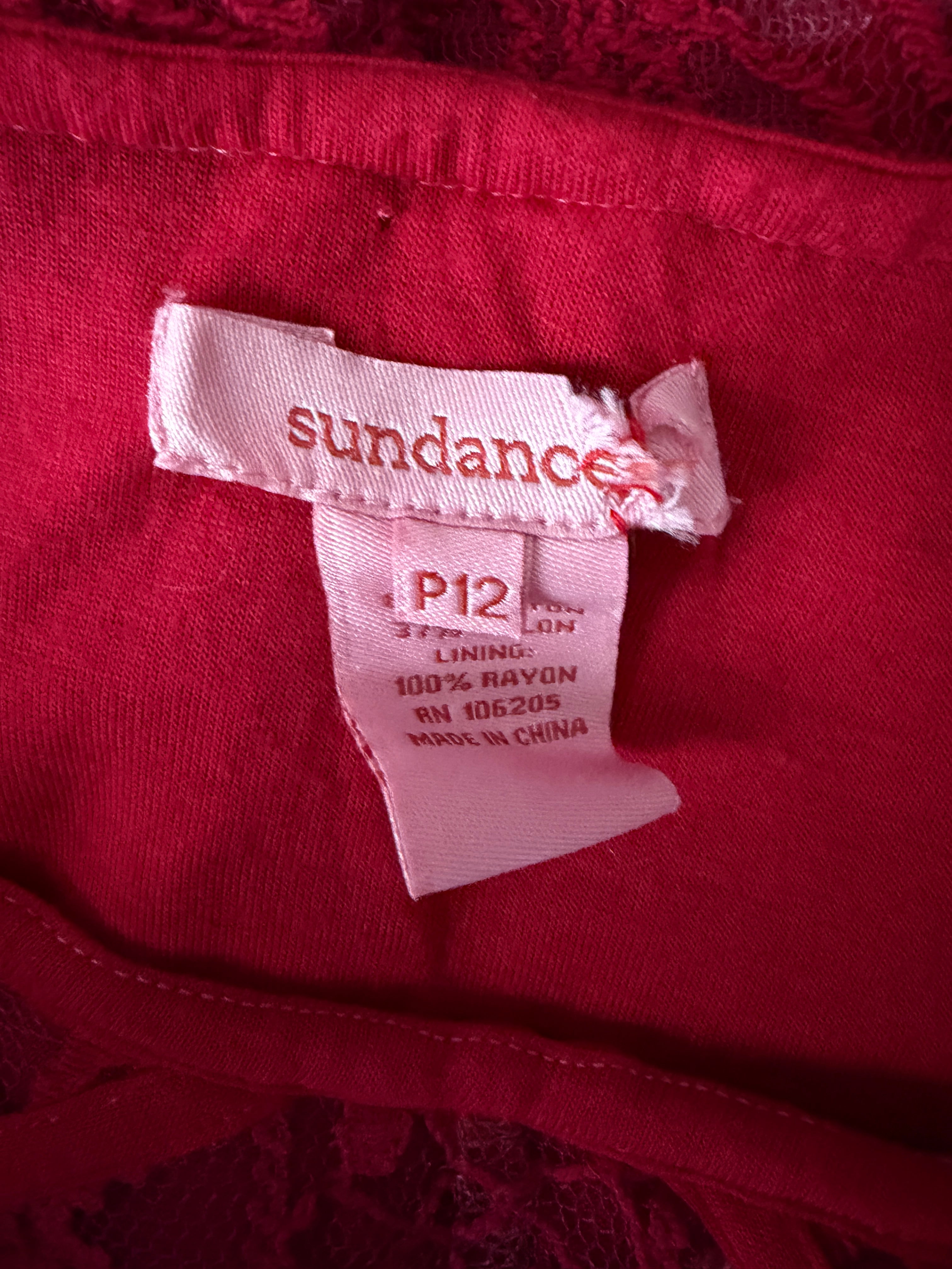 Close-up of a Sundance label on a red fabric background