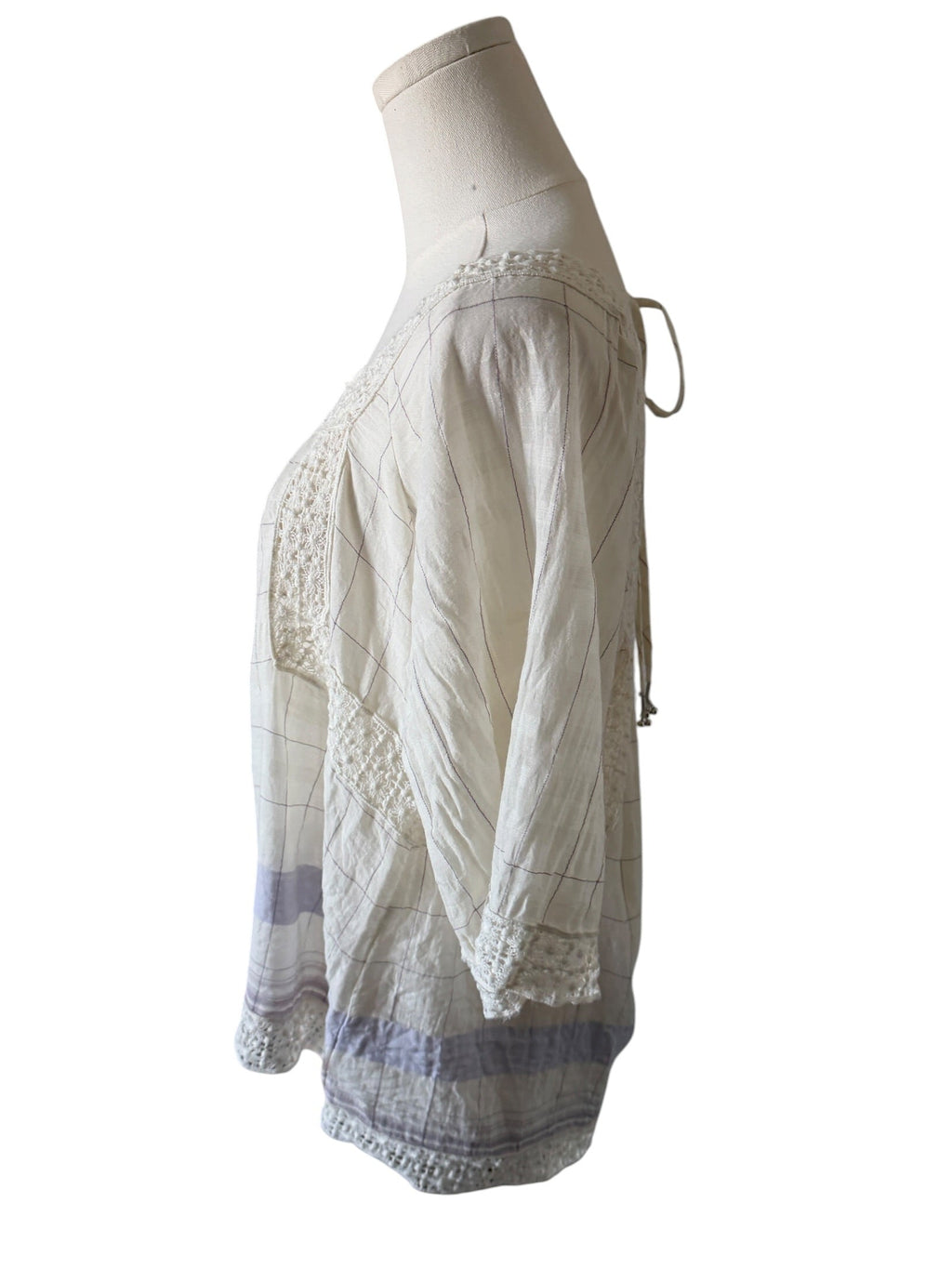 White lace dress on a mannequin against a white background