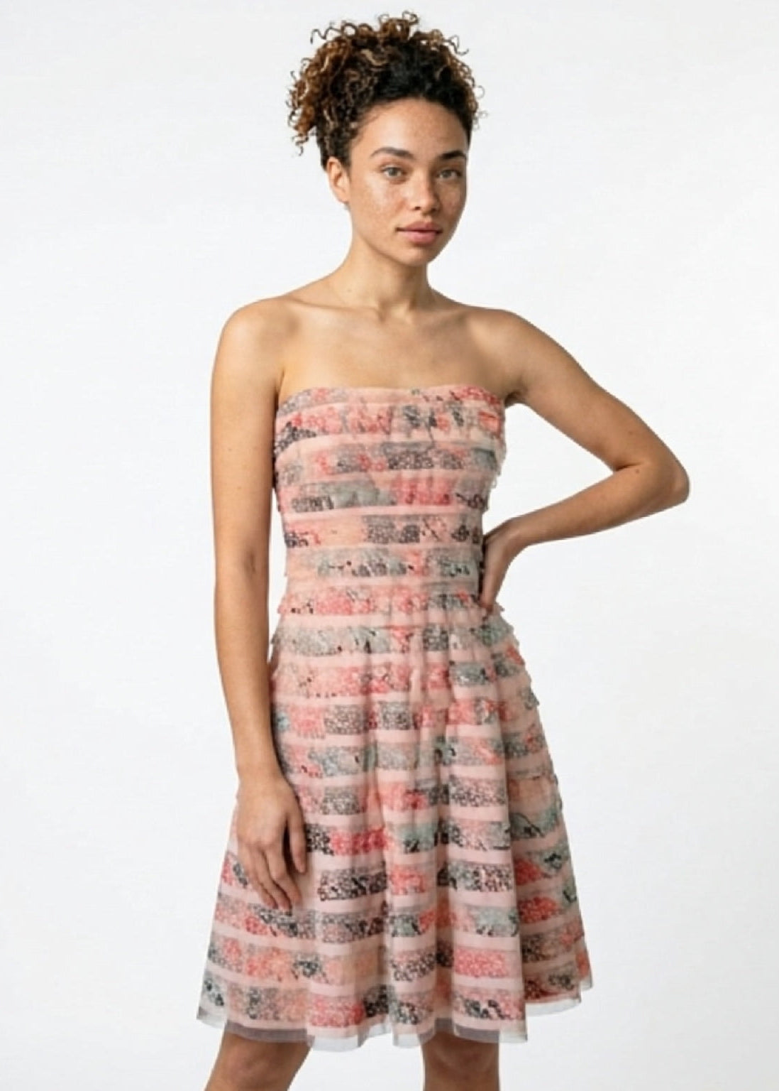 Woman wearing a strapless floral dress on a white background