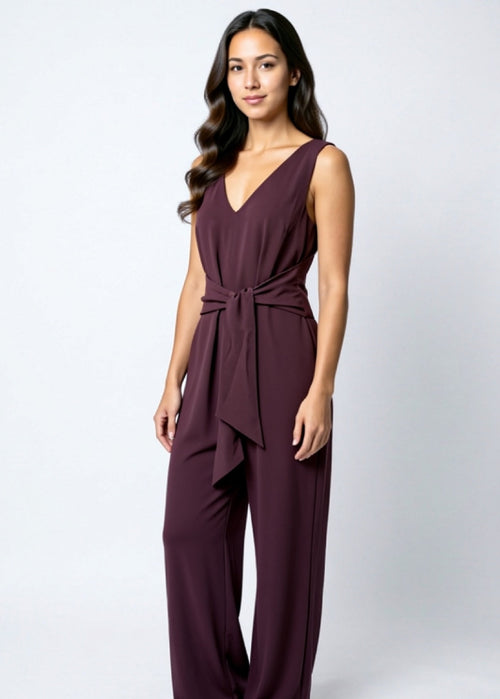 Woman wearing a purple jumpsuit on a white background