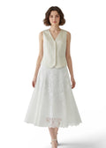 Woman wearing a white dress with a plain background