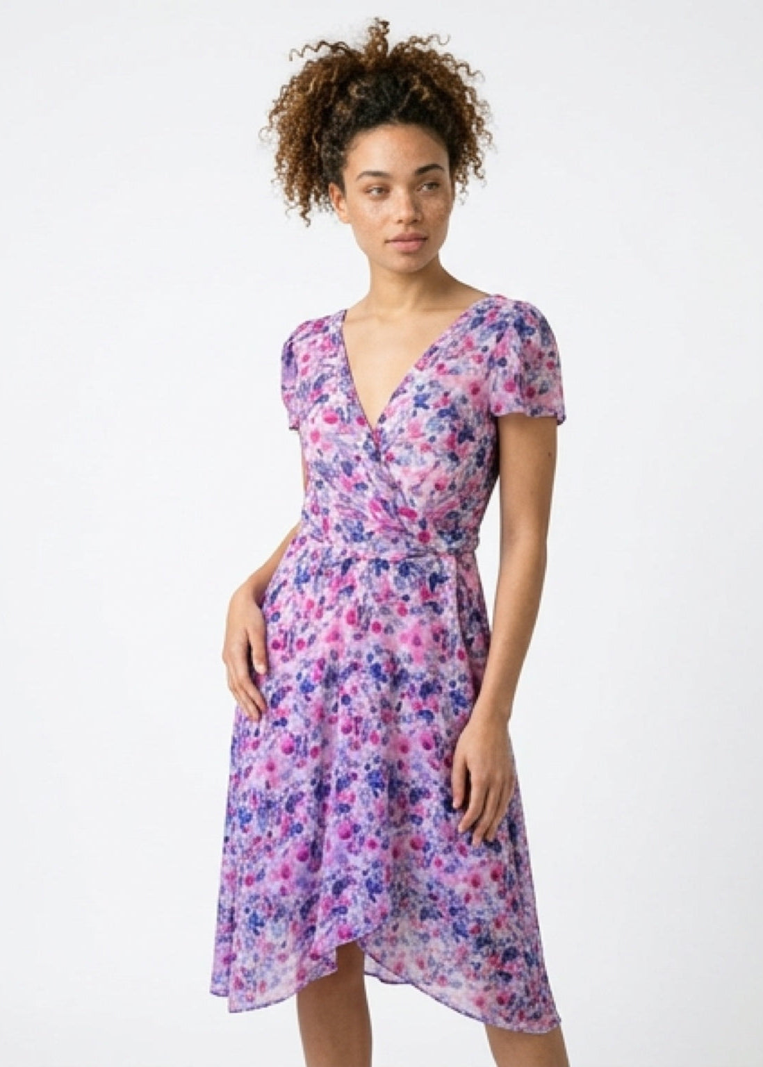 Woman wearing a floral dress on a white background