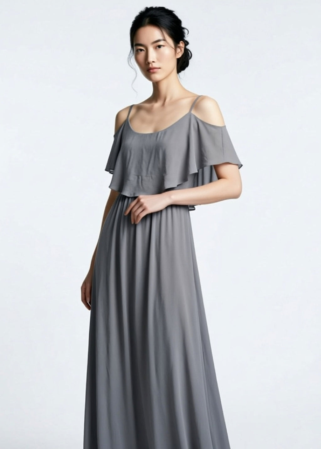 Woman wearing a gray off-shoulder dress on a white background