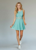Woman wearing a light blue dress with a plain background
