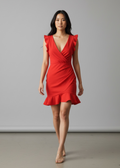 Woman wearing a red dress against a plain background