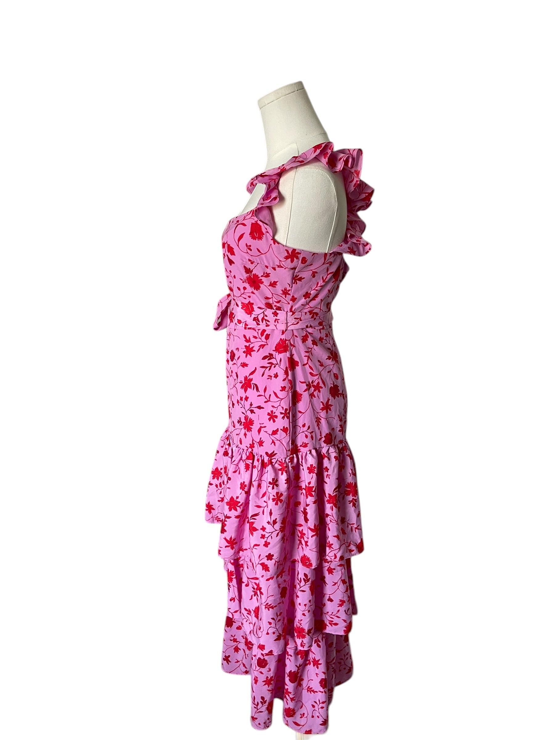 Pink floral dress on a mannequin against a white background
